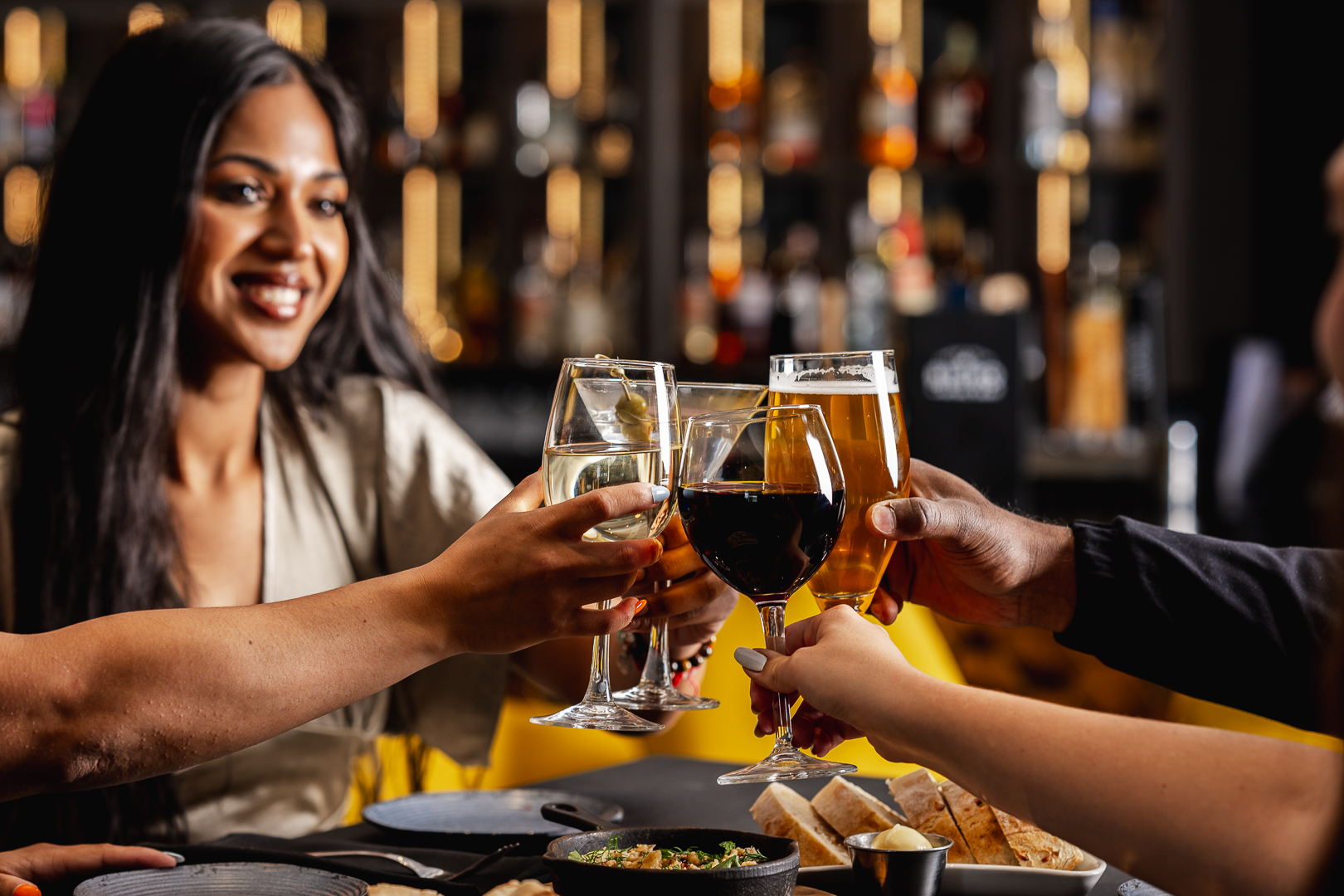 4 people cheerings their wine and beers