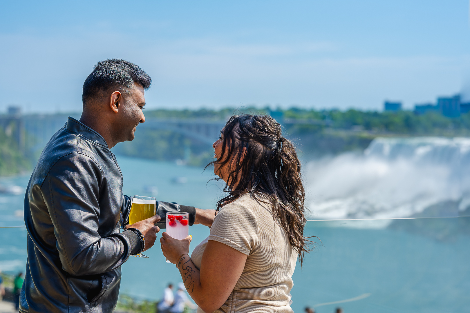 A man and woman looking over the patio to the horseshoe falls